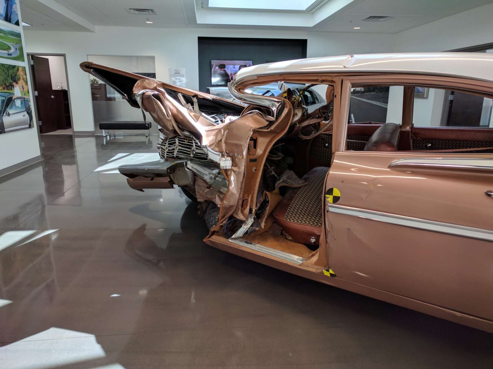 A 1959 Chevrolet Bel Air and a 2009 Chevrolet Malibu are on display in the IIHS Vehicle Research Center's lobby, demonstrating the advances in vehicle safety over the last several decades. (WTOP/Ginger Whitaker)
