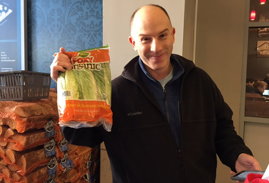 Resident Jason Levin is expecting lots of kids at his house due to a neighboring sledding hill. He got salad as well as frozen pizza and chips.  (WTOP/Jenny Glick)