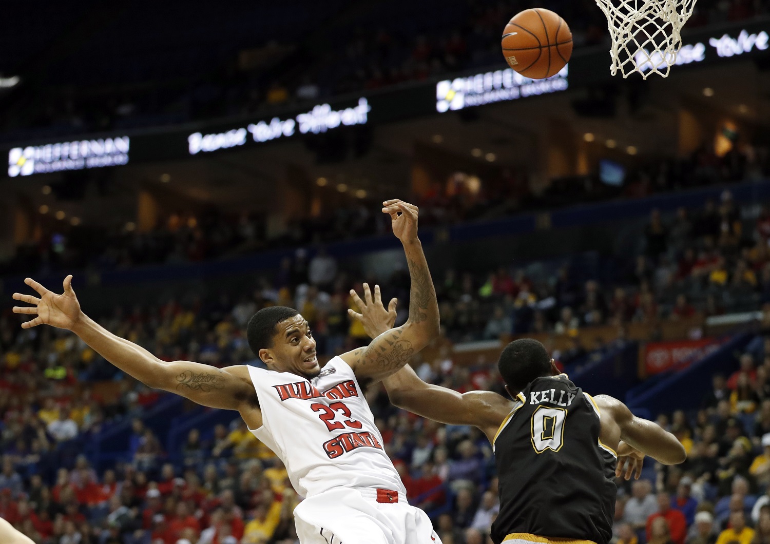 Illinois State's Deontae Hawkins, left, loses control of the ball after colliding with Wichita State's Rashard Kelly during the first half of an NCAA college basketball game in the championship of the Missouri Valley Conference men's tournament, Sunday, March 5, 2017, in St. Louis. (AP Photo/Jeff Roberson)