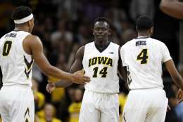 Iowa guard Peter Jok (14) celebrates with teammates Ahmad Wagner, left, and Isaiah Moss, right, during the second half of an NCAA college basketball game, Sunday, March 5, 2017, in Iowa City, Iowa. Iowa won 90-79. (AP Photo/Charlie Neibergall)