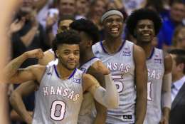Kansas players Frank Mason III (0), Lagerald Vick, Carlton Bragg Jr. (15) and Josh Jackson (11) during the second half of an NCAA college basketball game against TCU in Lawrence, Kan., Wednesday, Feb. 22, 2017. Kansas defeated TCU 87-68. The Jayhawks clinched at least a tie for their 13th straight Big 12 title. (AP Photo/Orlin Wagner)