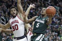 Michigan State guard Cassius Winston (5) makes a layup defended by Nebraska forward Ed Morrow (30) during the second half of an NCAA college basketball game, Thursday, Feb. 23, 2017, in East Lansing, Mich. (AP Photo/Carlos Osorio)