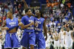 Middle Tennessee Darnell Harris (0), Perrin Buford (2) and Jaqawn Raymond, left, celebrate as they walk off the court after winning a first-round men's college basketball game against Michigan State in the NCAA Tournament, Friday, March 18, 2016, in St. Louis. Middle Tennessee won 90-81. (AP Photo/Charlie Riedel)