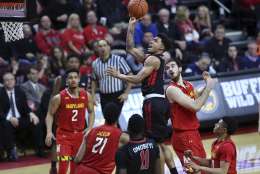 Rutgers guard Corey Sanders shoots over Maryland defenders during the second half of an NCAA college basketball game Tuesday, Feb. 28, 2017, in Piscataway, N.J. (AP Photo/Mel Evans)