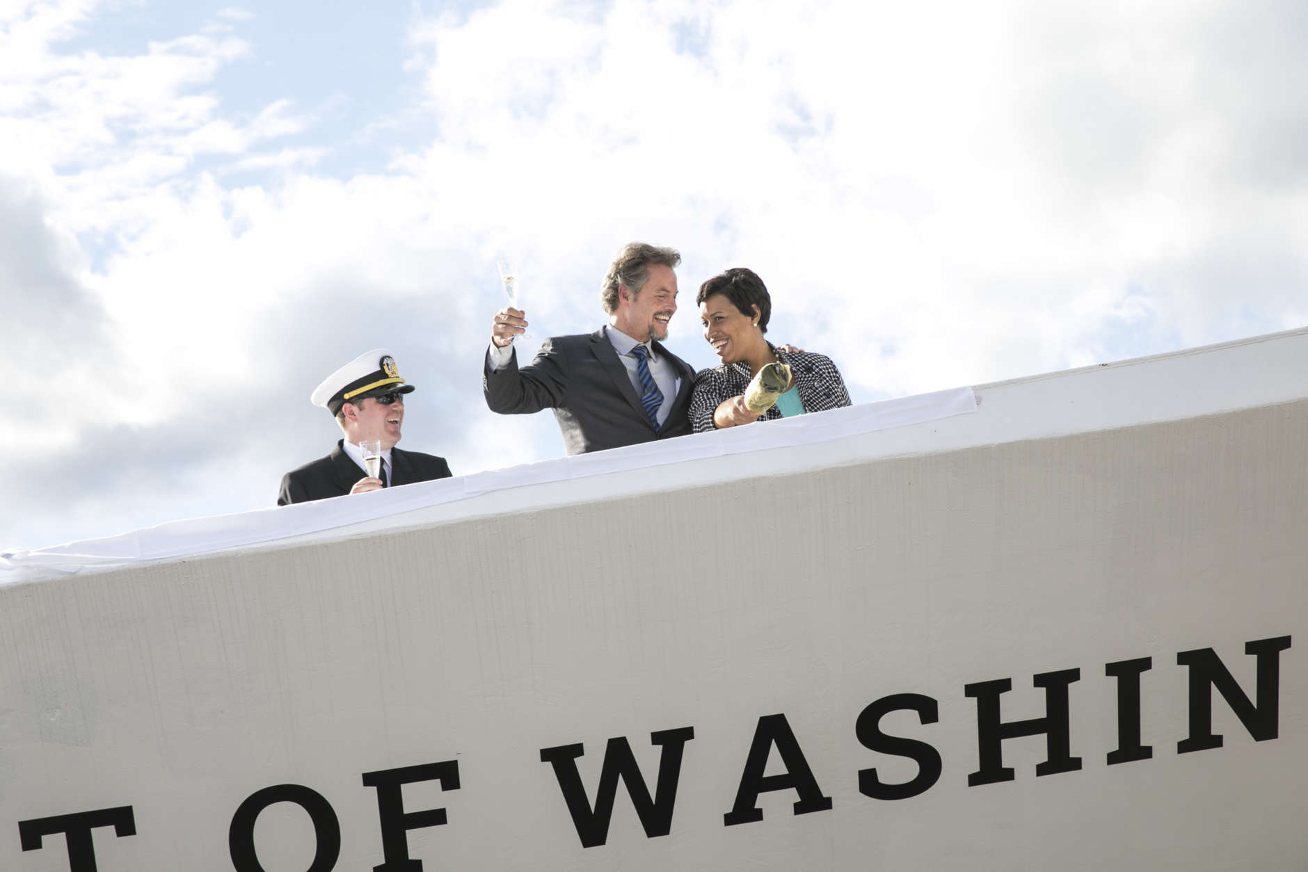 Captain Nate Handy and Entertainment Cruises CEO Kenneth Svendsen join DC Mayor Muriel Bowser in christening the new Spirit of Washington Yacht at The Wharf's Pier 4 Tuesday afternoon. (Jason Dixson Photography)