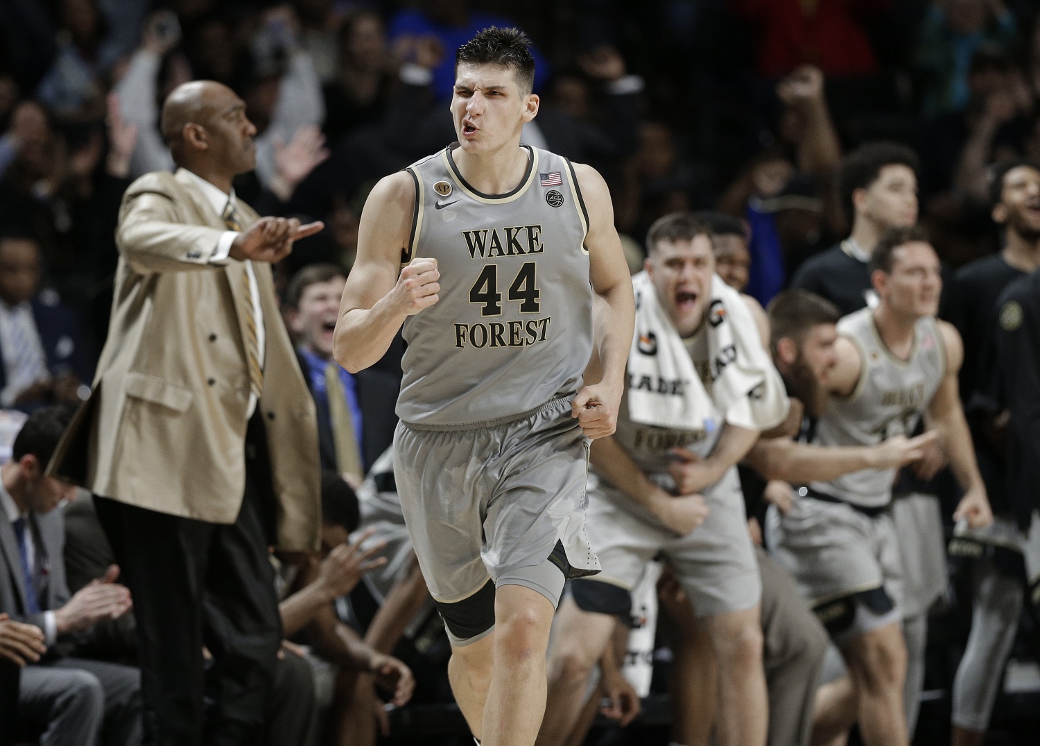 Wake Forest's Konstantinos Mitoglou (44) celebrates after a basket against Louisville during the second half of an NCAA college basketball game in Winston-Salem, N.C., Wednesday, March 1, 2017. Wake Forest won 88-81. (AP Photo/Chuck Burton)