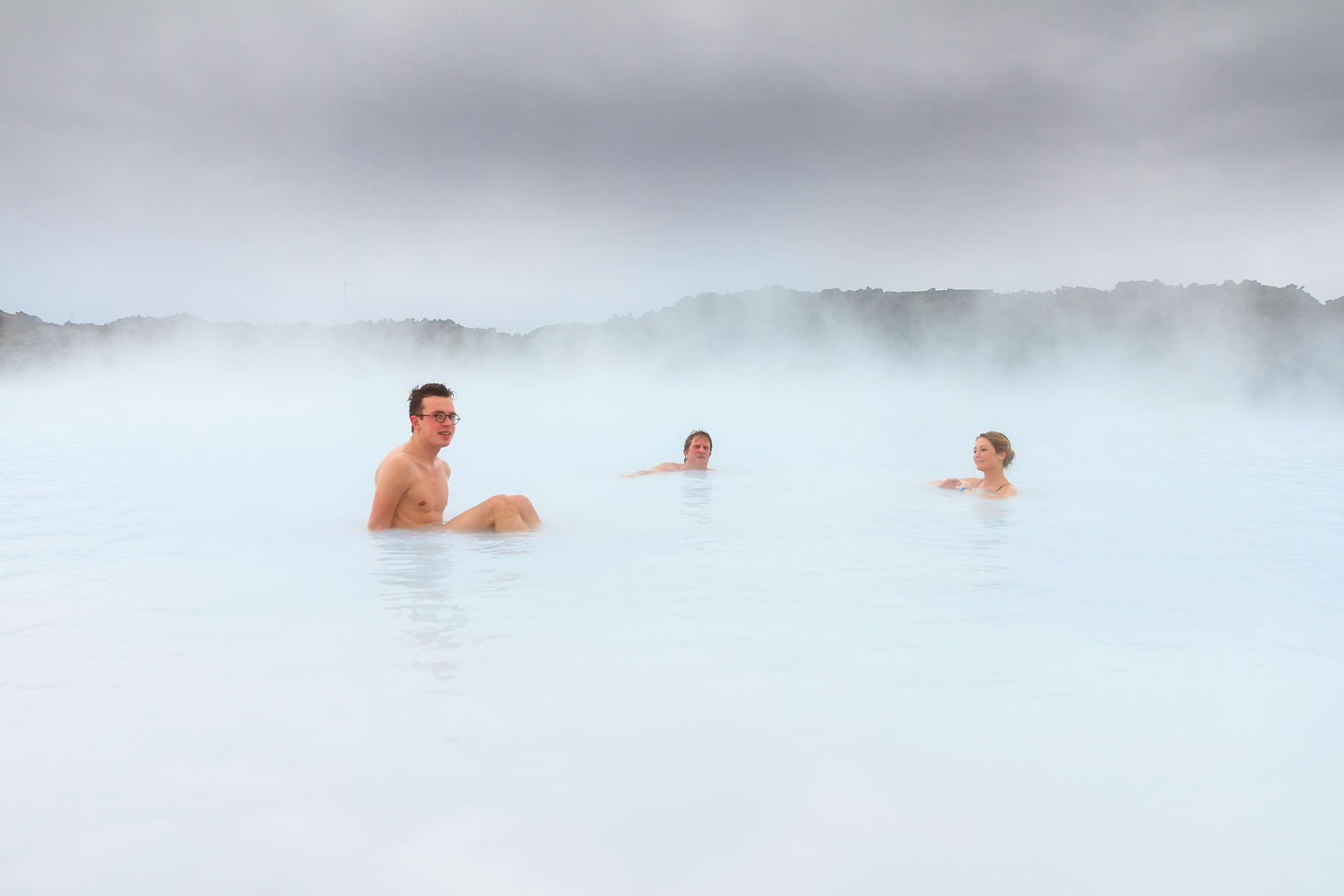 Sick people healing in the blue mineral waters of a geothermal spa in Iceland