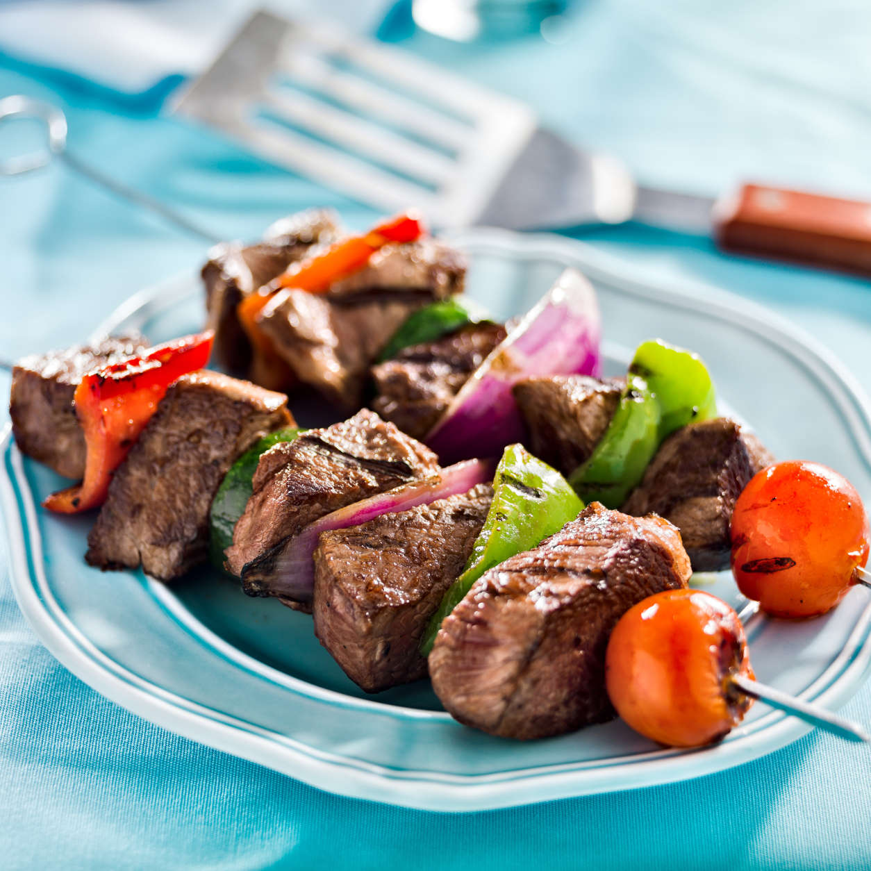 close up photo of grilled beef shishkabobs on table shot with selective focus. (Getty Images)