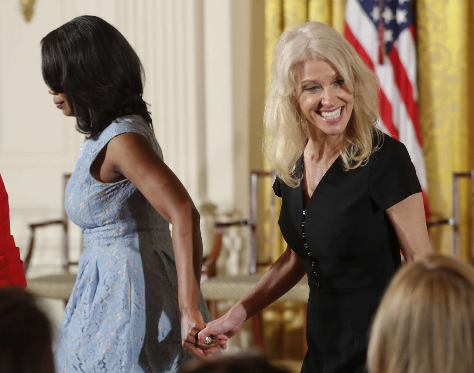 White House Director of communications for the Office of Public Liaison Omarosa Manigault, left, and Counselor to the President Kellyanne Conway, take their seats at the Women's Empowerment Panel, Wednesday, March 29, 2017, at the White House in Washington. (AP Photo/Pablo Martinez Monsivais)