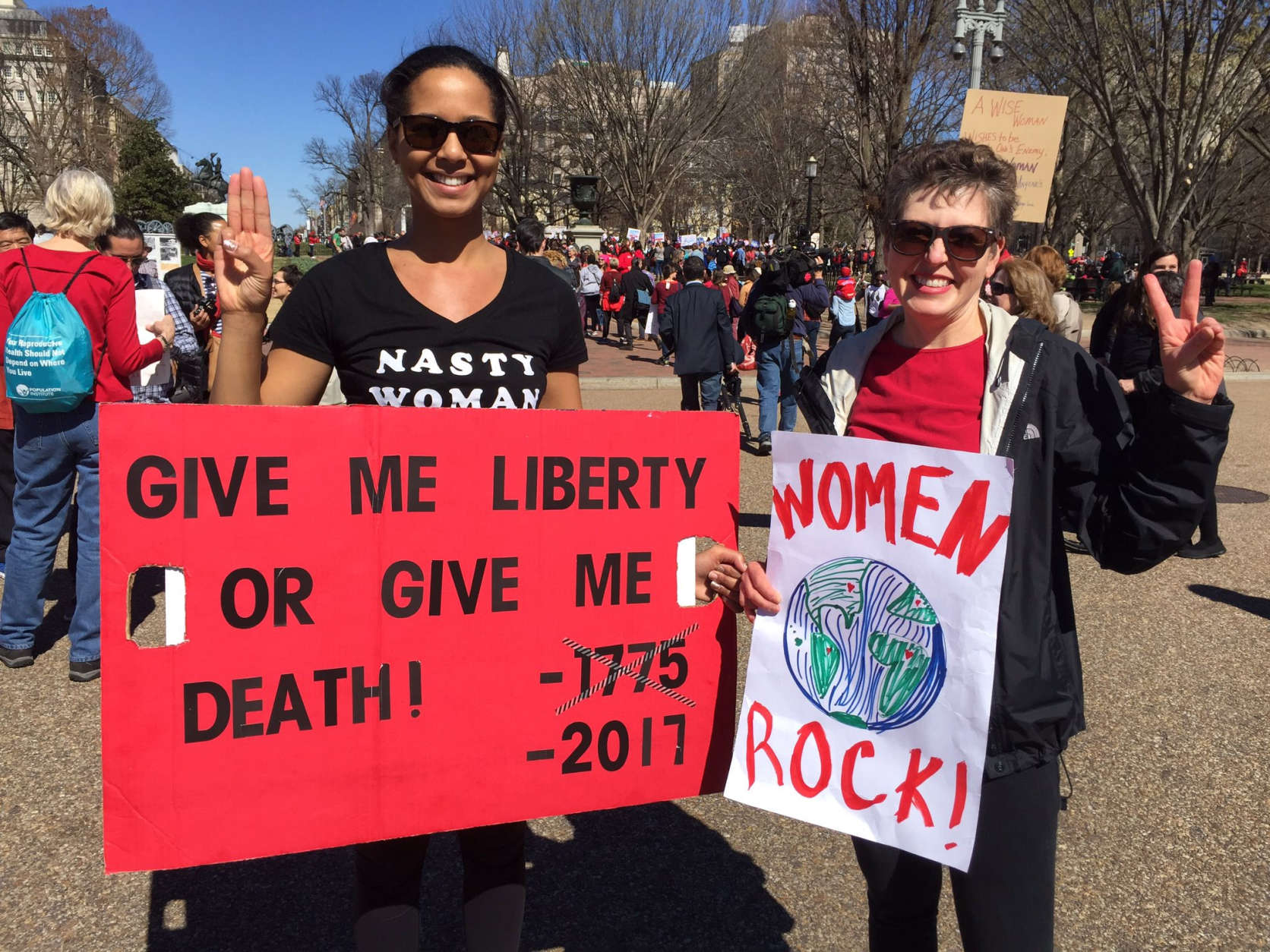 Two women join a march in D.C. as part of a Day without a Woman on Wednesday, March 8, 2017. (WTOP/Kristi King)