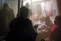 Smoke fills a Washington Metro system subway car near the L'Enfant Plaza station in Washington, Monday, Jan. 12, 2015. The transit network in the nation's capital remained hobbled Tuesday morning after an electrical malfunction that filled the busy subway station with smoke, killing one woman and sending dozens of people to hospitals. (AP Photo/Andrew Litwin)