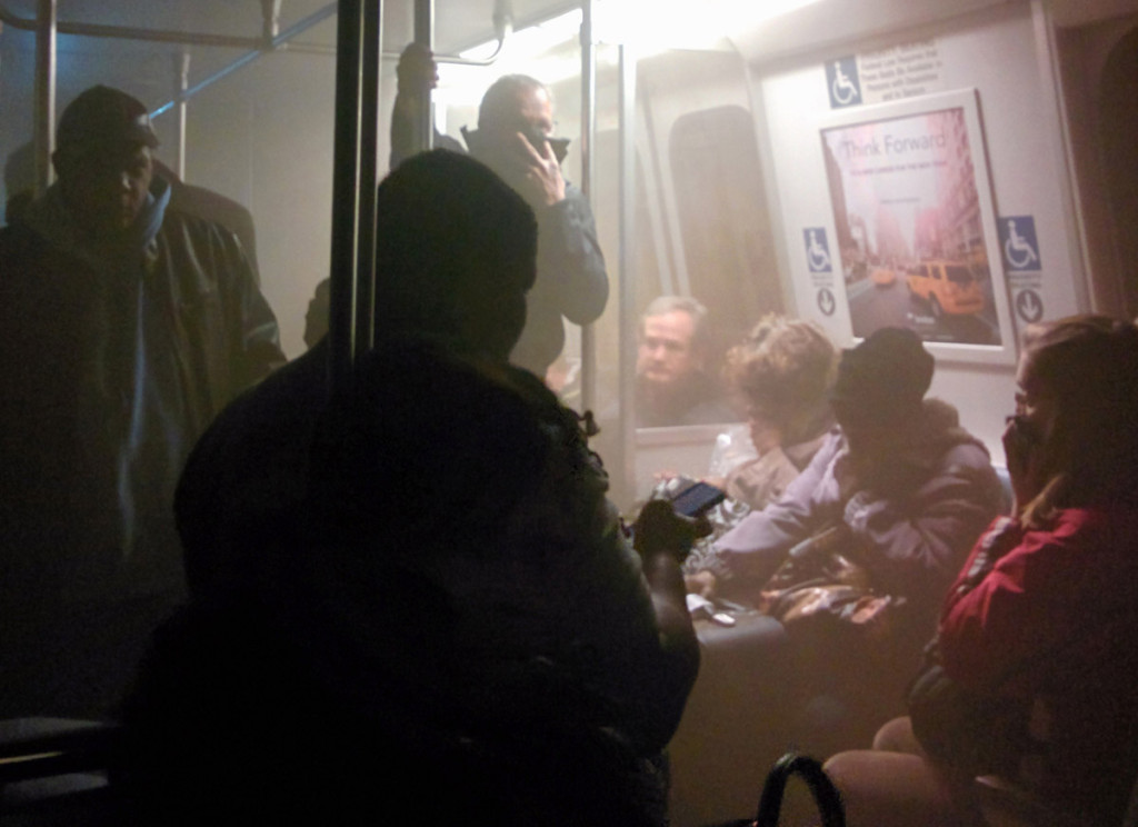 Smoke fills a Washington Metro system subway car near the L'Enfant Plaza station in Washington, Monday, Jan. 12, 2015. The transit network in the nation's capital remained hobbled Tuesday morning after an electrical malfunction that filled the busy subway station with smoke, killing one woman and sending dozens of people to hospitals. (AP Photo/Andrew Litwin)