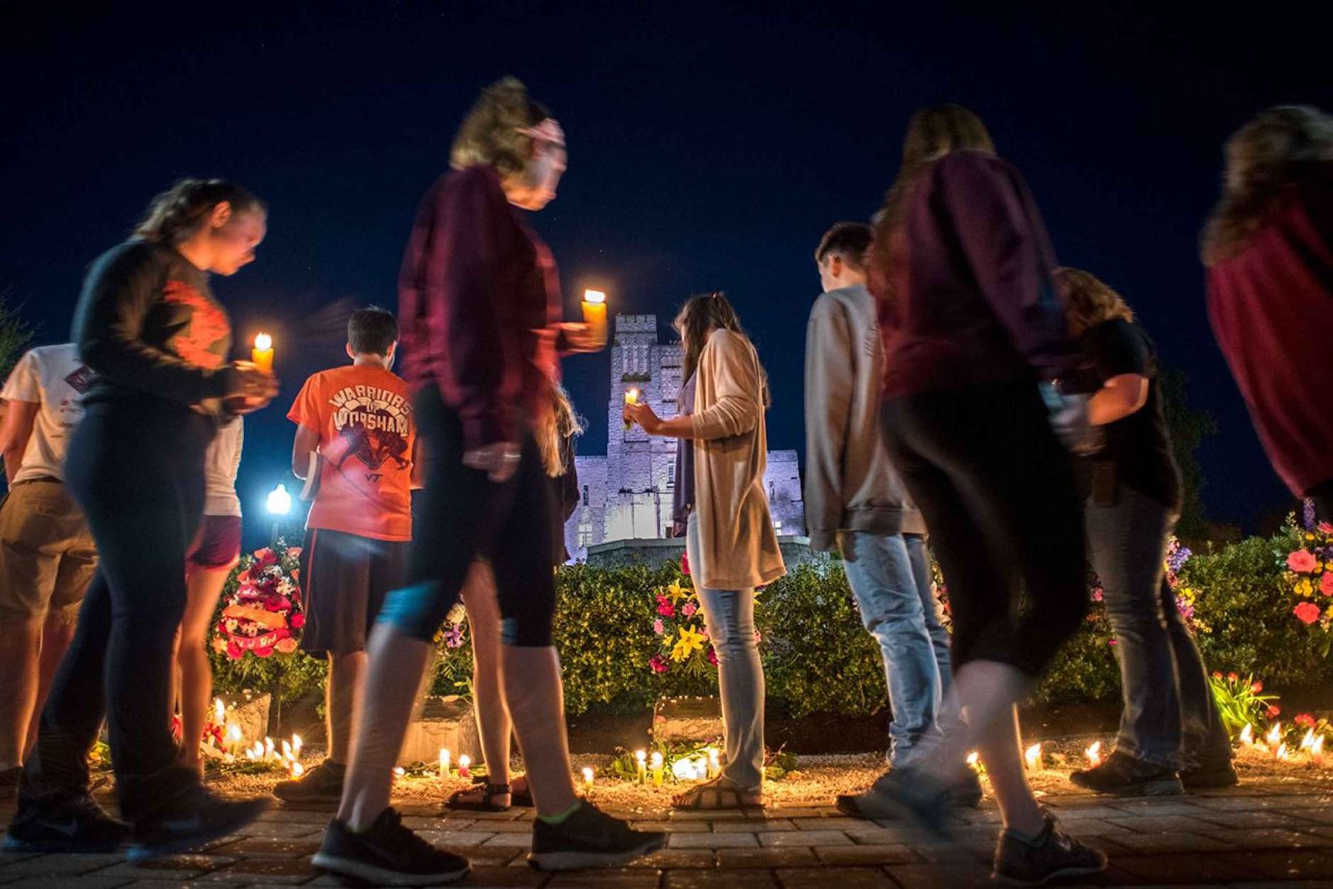 Many who attended the candelight vigil Sunday evening stayed to visit the April 16 Memorial. The vigil was one of many events on campus to mark the 2017 Day of Remembrance. (Courtesy Virginia Tech)