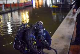 A diver helps get the ATM out of the Baltimore Inner Harbor Thursday after powerful storms moved it into the water. (Courtesy Baltimore police)