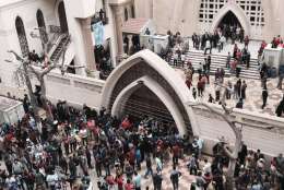 Relatives and onlookers gather outside a church after a bomb attack in the Nile Delta town of Tanta, Egypt, Sunday, April 9, 2017. The attack took place on Palm Sunday, the start of the Holy Week leading up to Easter, when the church in the Nile Delta town of Tanta was packed with worshippers. (AP Photo/Nariman El-Mofty)