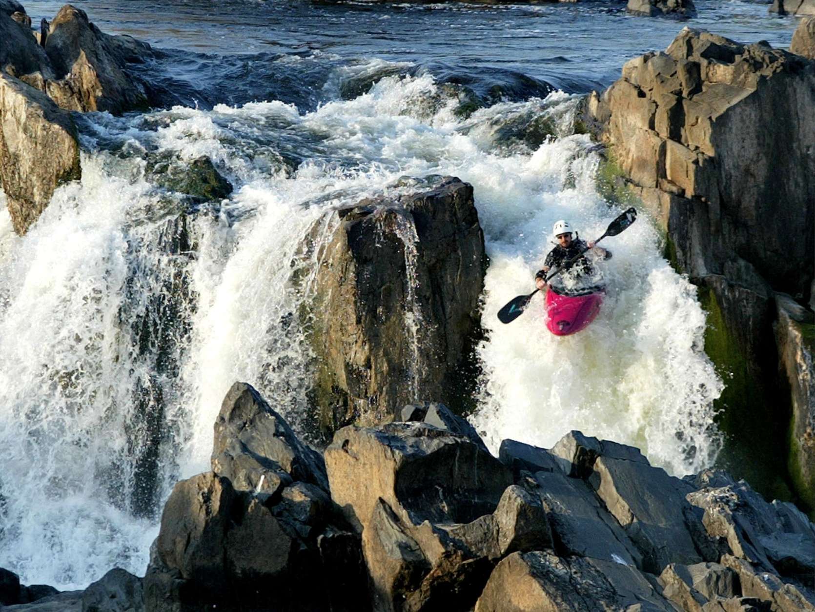A local kayaker cools off  making his way through a roaring set of rapids Monday, Aug. 19, 2002, at Great Falls in northern Virginia. (AP Photo/Ron Edmonds)