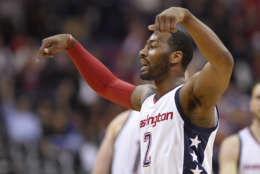 Washington Wizards guard John Wall (2) gestures after a basket during the second half in Game 5 of the team's first-round NBA basketball playoff series against the Atlanta Hawks, Wednesday, April 26, 2017, in Washington. The Wizards won 103-99. (AP Photo/Nick Wass)