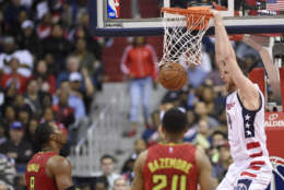 Washington Wizards forward Jason Smith (14) dunks against Atlanta Hawks center Dwight Howard (8) and forward Kent Bazemore (24) during the second half in Game 5 of a first-round NBA basketball playoff series, Wednesday, April 26, 2017, in Washington. The Wizards won 103-99. (AP Photo/Nick Wass)