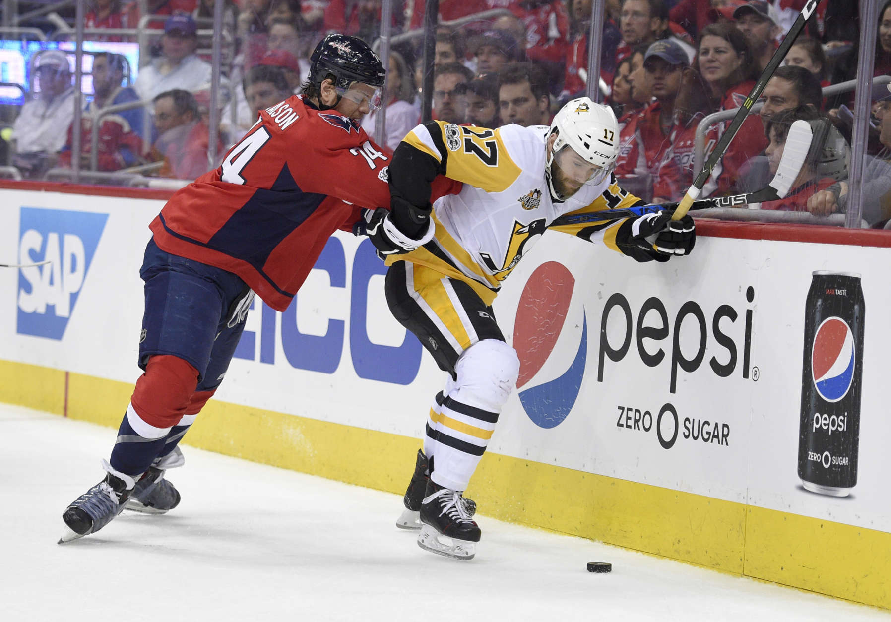 Washington Capitals defenseman John Carlson (74) vies for the puck against Pittsburgh Penguins right wing Bryan Rust (17) during the first period of Game 1 in an NHL hockey Stanley Cup second-round playoff series, Thursday, April 27, 2017, in Washington. (AP Photo/Nick Wass)