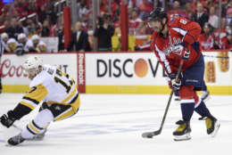 Washington Capitals left wing Alex Ovechkin (8), of Russia, skates with the puck against Pittsburgh Penguins right wing Bryan Rust (17) during the second period of Game 1 in an NHL hockey Stanley Cup second-round playoff series, Thursday, April 27, 2017, in Washington. (AP Photo/Nick Wass)