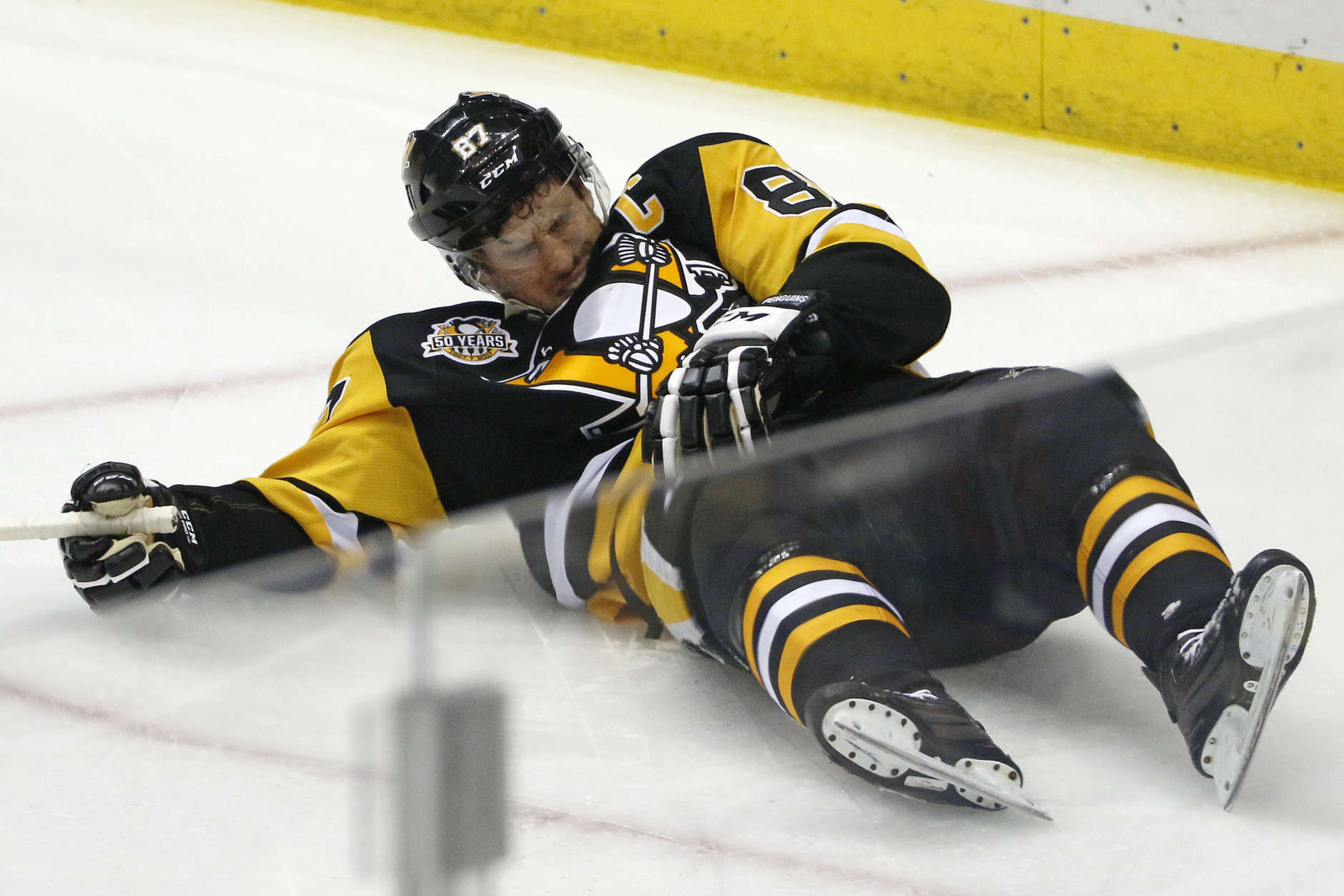 Pittsburgh Penguins' Sidney Crosby (87) lies on the ice after taking a hit from Washington Capitals' Matt Niskanen during the first period of Game 3 in an NHL Stanley Cup Eastern Conference semifinal hockey game against the Washington Capitals in Pittsburgh, Monday, May 1, 2017. (AP Photo/Gene J. Puskar)
