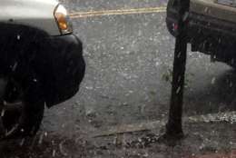 Photos of hail falling onto a parked car