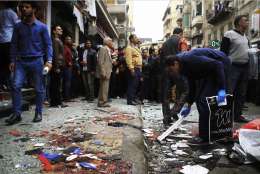 People clean up debris after an explosion hit Saint Mark's Cathedral in the coastal city of Alexandria, the historic seat of Christendom in Egypt, Sunday, April 9, 2017, killing several people, just after Pope Tawadros II finished services. Bombs tore through two Egyptian churches in different cities as worshippers were marking Palm Sunday, both claimed by the Islamic State group. (AP Photo/Hazem Gouda)