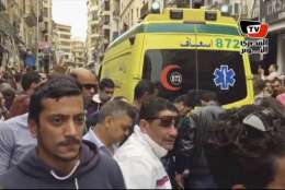 This frame grab from video shows an ambulance outside Saint Mark's Cathedral following a suicide bombing that killed several people, just after Coptic Pope Tawadros II finished services, in the coastal city of Alexandria, Egypt, Sunday, April 9, 2017. Bombs tore through two Egyptian churches in different cities as worshippers were marking Palm Sunday, both claimed by the Islamic State group. (AL-MASRY AL-YOUM, via AP)