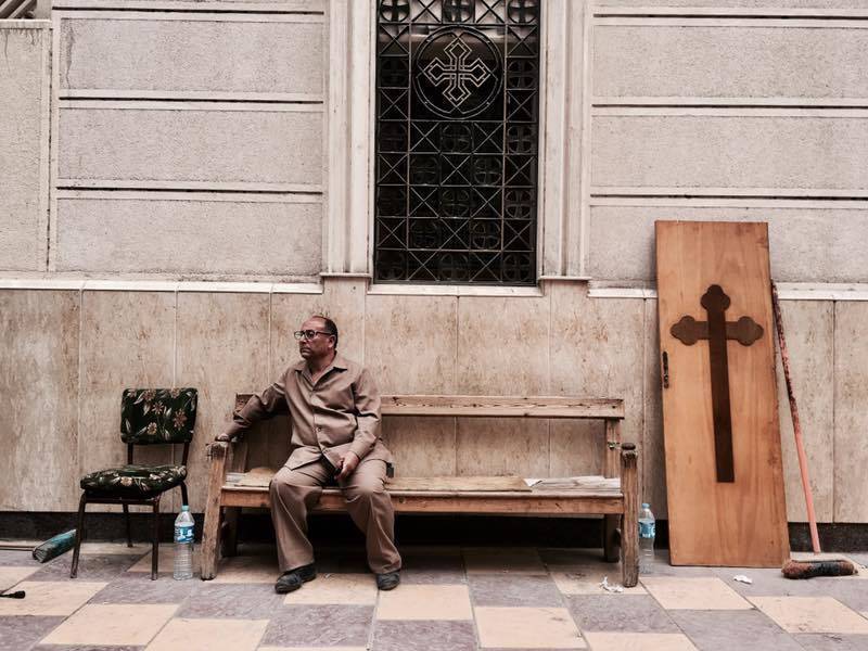 A man sits on a bench outside a church after a bomb attack in the Nile Delta town of Tanta, Egypt, Sunday, April 9, 2017. The attack took place on Palm Sunday, the start of the Holy Week leading up to Easter, when the church in the Nile Delta town of Tanta was packed with worshippers. (AP Photo/Nariman El-Mofty)