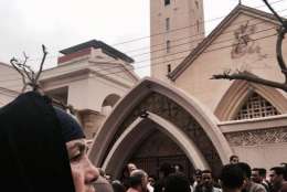 Relatives and onlookers gather outside a church after a bomb attack in the Nile Delta town of Tanta, Egypt, Sunday, April 9, 2017. The attack took place on Palm Sunday, the start of the Holy Week leading up to Easter, when the church in the Nile Delta town of Tanta was packed with worshippers. (AP Photo/Nariman El-Mofty)