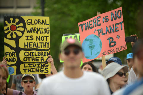 Trump policy protesters mark his 100th day with climate march