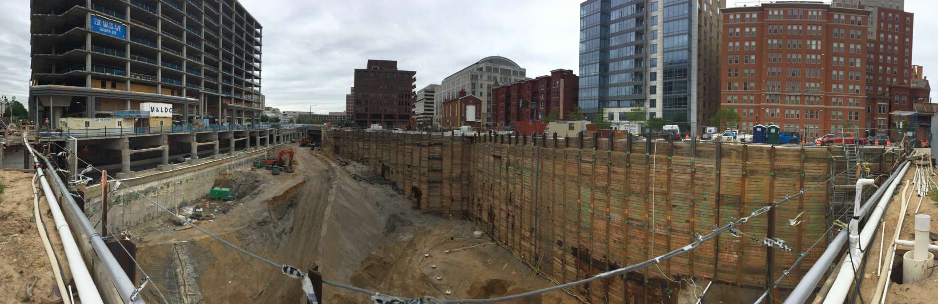 This hole for the 250 Massachusetts Ave.  property also will include a parking garage with spaces for about 1,200 vehicles and 400 bicycles. (WTOP/Kristi King)