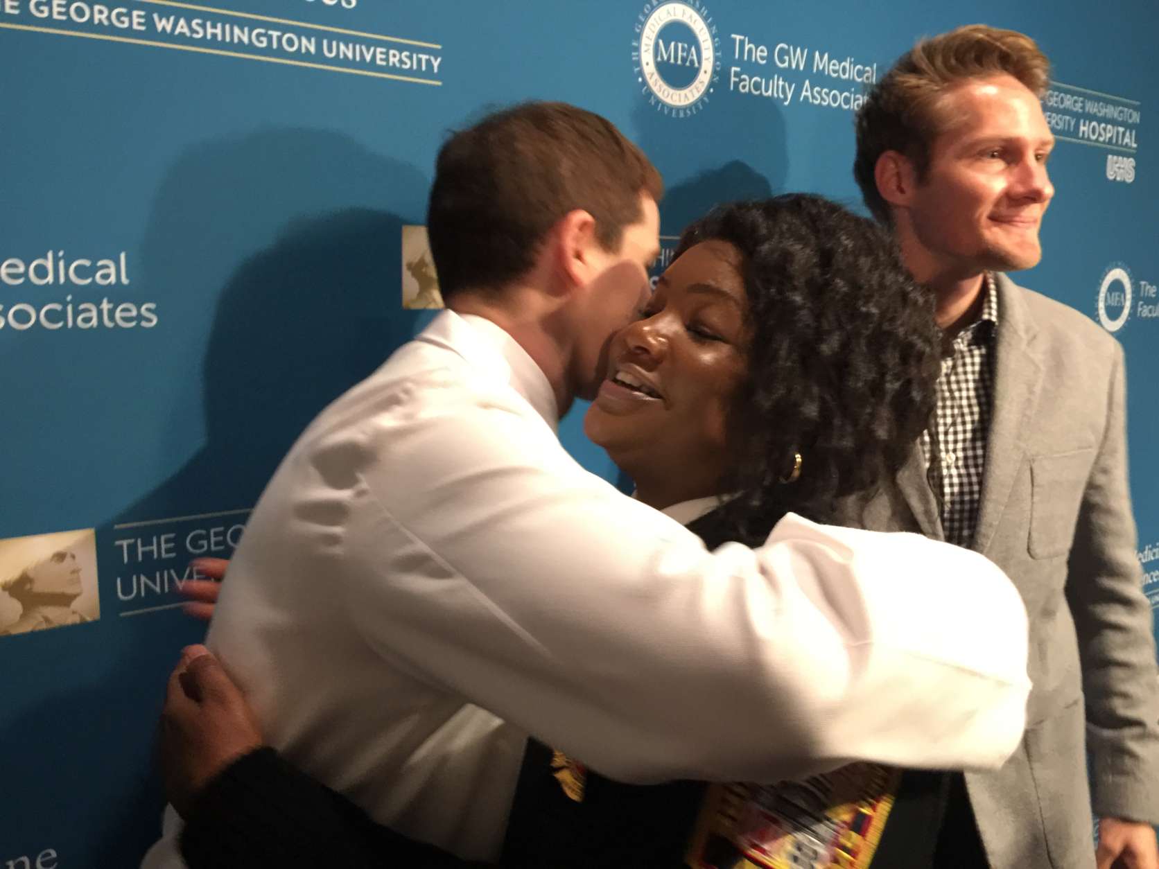 At a gathering to recognize people who helped save her life March 28, Angelia Boddie received hugs from more than a dozen people who came to her assistance on the streets of D.C. and at The George Washington University Hospital. (WTOP/Kristi King)