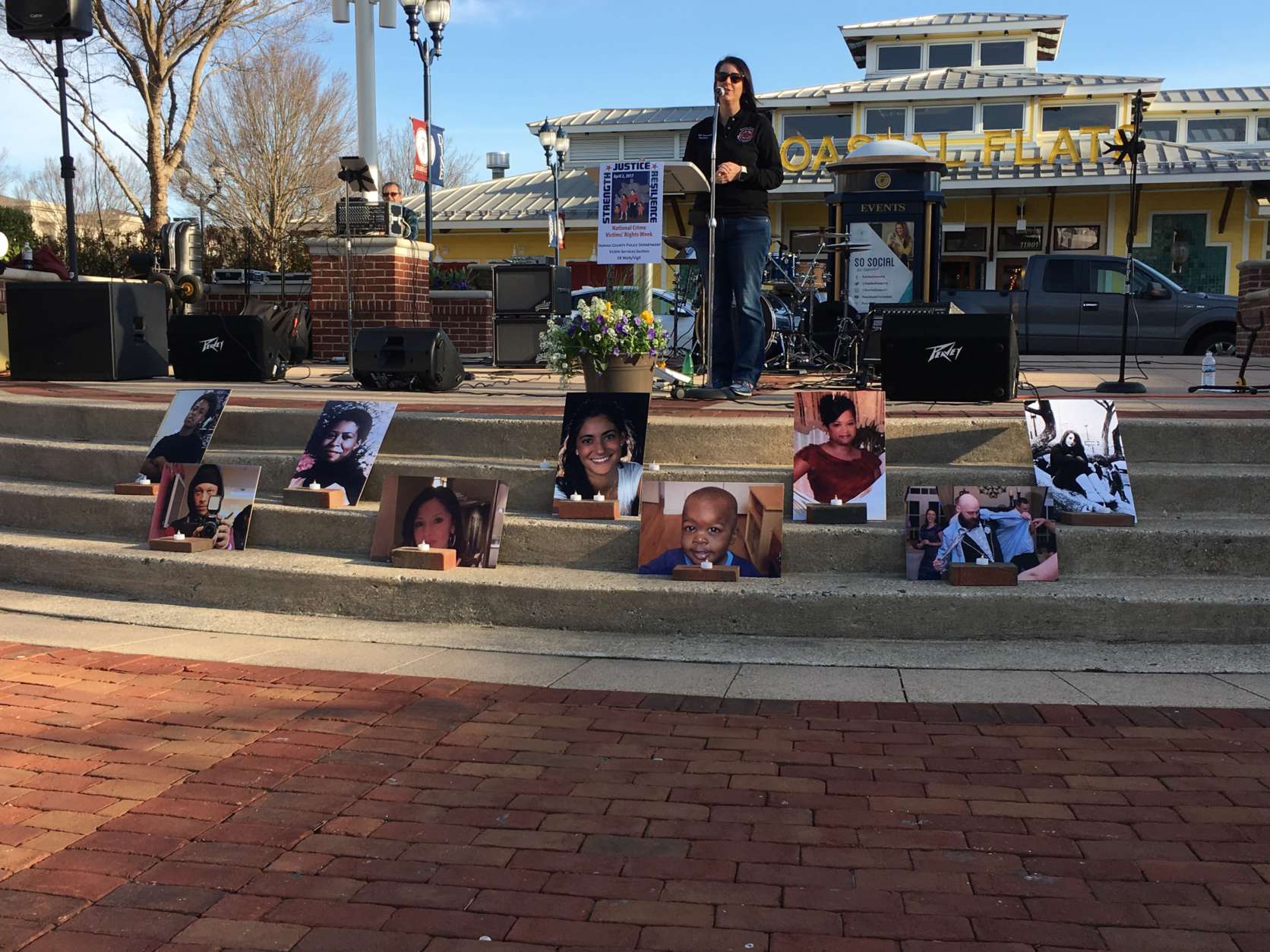 Photos of nine victims of crime in Fairfax County who were remembered during Sunday's vigil and 5K walk. (WTOP/Liz Anderson)