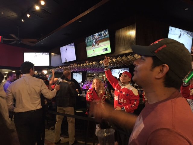 Capitals fans at the Green Turtle in D.C. cheer a goal during Game 5 against the Pittsburgh Penguins on  Saturday, May 7, 2017. (WTOP/Jenny Glick)