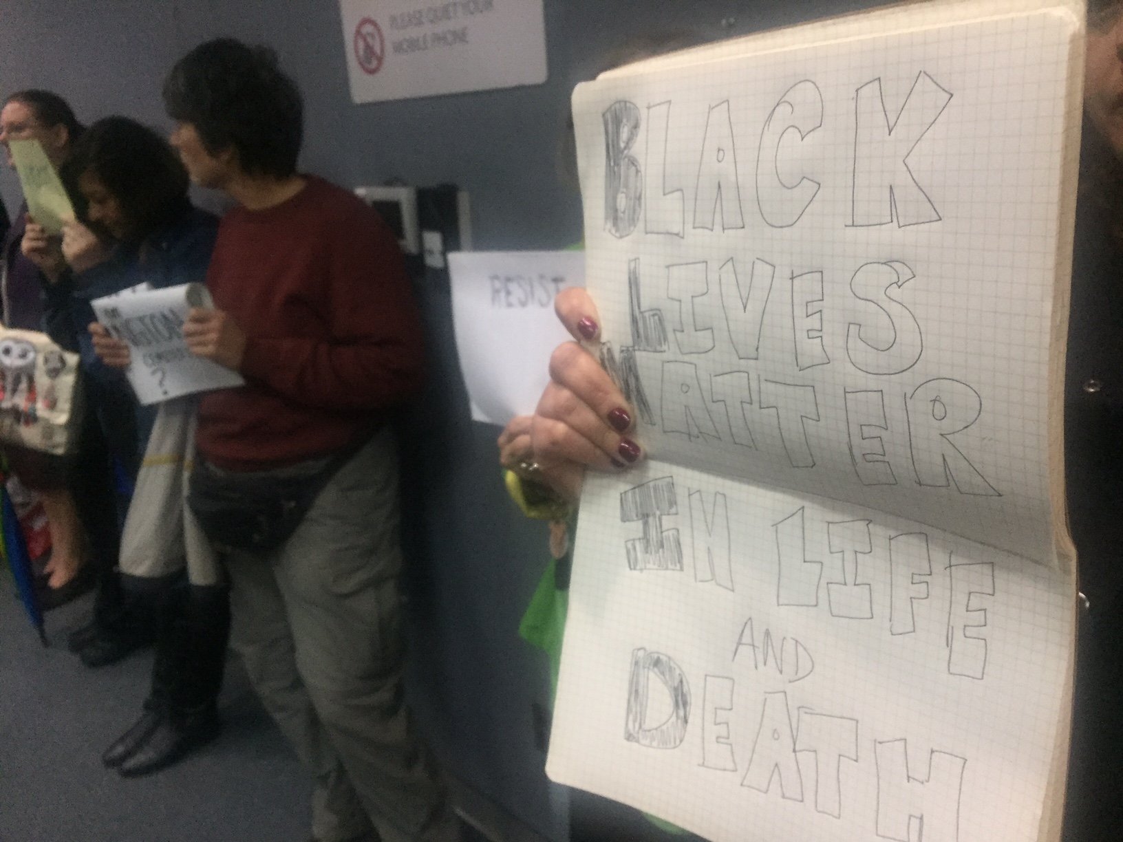 About 20 protesters stood in the back and held signs during the Montgomery County Planning Board’s meeting in Silver Spring. (WTOP/John Aaron)