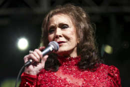 FILE - In this March 17, 2016 file photo, Loretta Lynn performs at the BBC Music Showcase at Stubb's during South By Southwest  in Austin, Texas. The eight-time CMA winner was the very first female vocalist of the year and she’s planning be at the 50th annual CMA Awards next Wednesday as many of her career milestones have played out on that stage. (Photo by Rich Fury/Invision/AP, File)