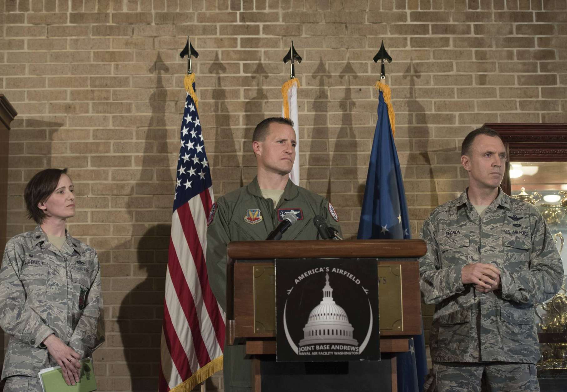 From left, Lt. Col. Lisa Mabbutt, Lt. Colonel Michael Croker and Brigadier General George Degnon of the D.C. Air National Guard, participate in a news conference at Andrews Air Force Base, Md., Wednesday, April 5, 2017, about the military aircraft crash in Clinton, Md.  A fighter pilot on a training mission ejected safely before the jet crashed in a wooded area in a Washington suburb. Witnesses reported the sound of live ammunition. (AP Photo/Sait Serkan Gurbuz)