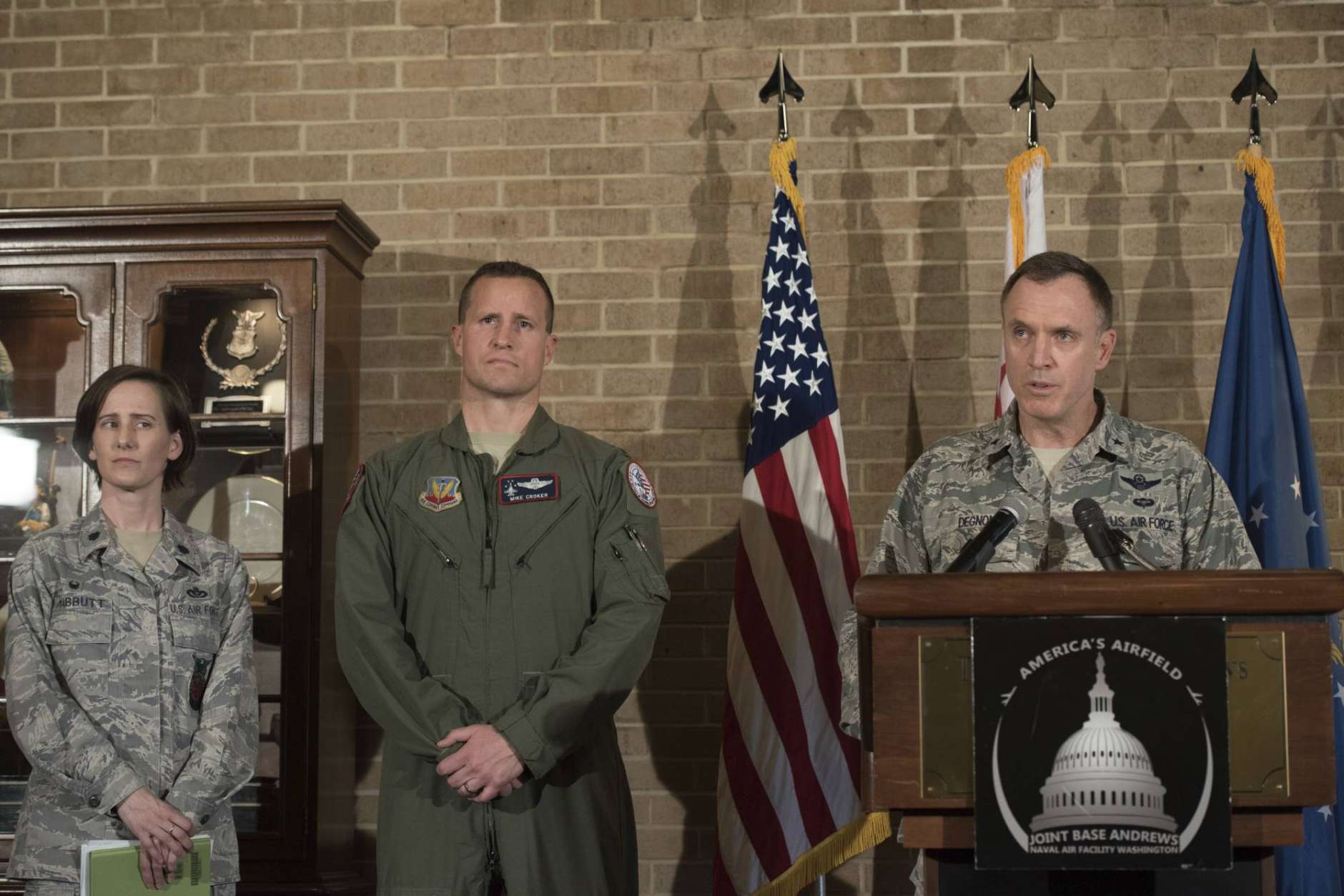 Brigadier Gen. George Degnon, the acting adjutant general of the D.C. Air National Guard, left, accompanied by Lt. Colonel Lisa Mabbutt, left, and Lt. Colonel Michael Croker, speaks during a news conference at Andrews Air Force Base, Md., Wednesday, April 5, 2017, about the military aircraft crash in Clinton, Md. A fighter pilot on a training mission ejected safely before the jet crashed in a wooded area in a Washington suburb. Witnesses reported the sound of live ammunition. (AP Photo/Sait Serkan Gurbuz)