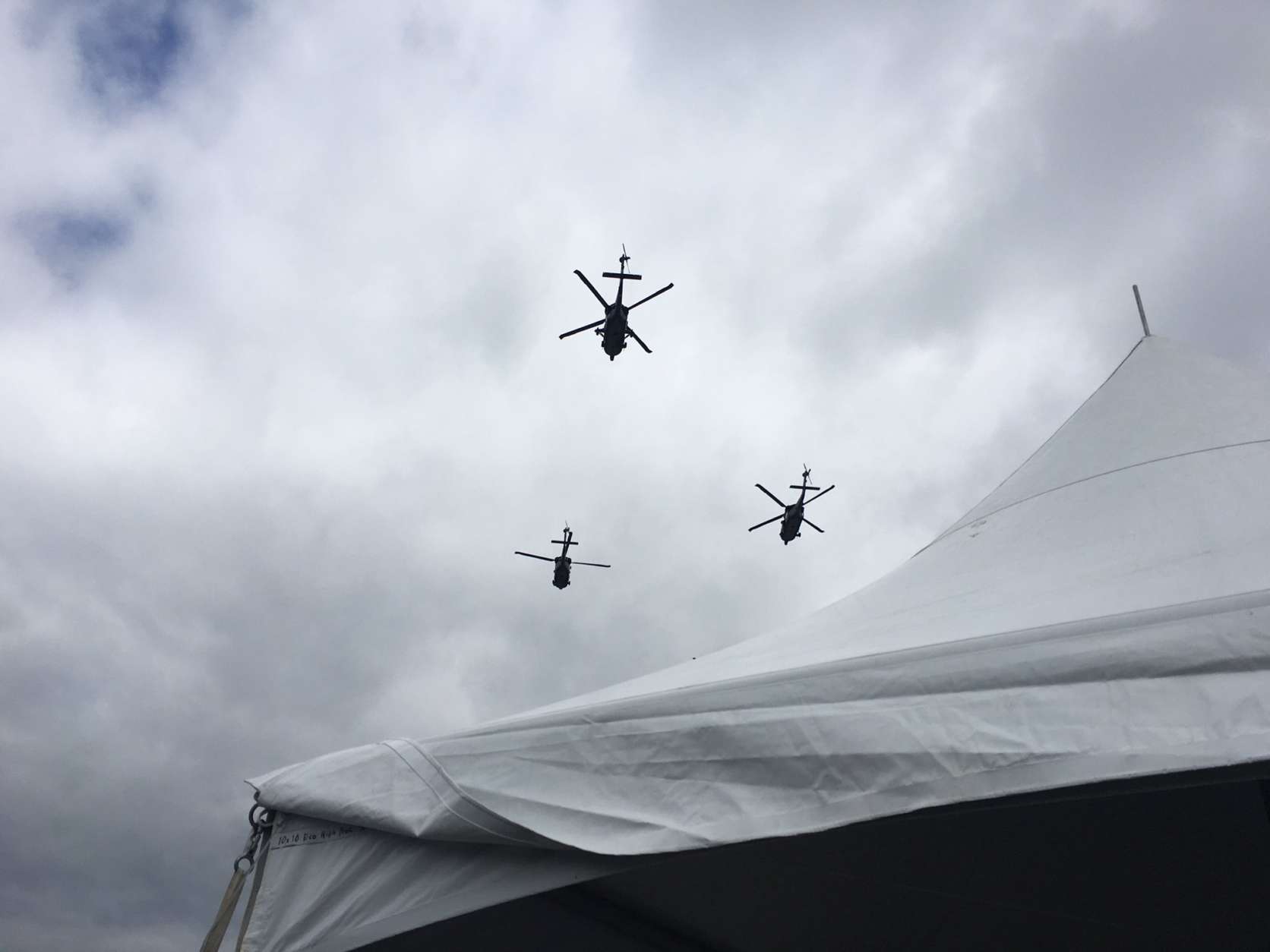 Helicopters fly overhead at the Naval Academy. (WTOP/George Wallace)