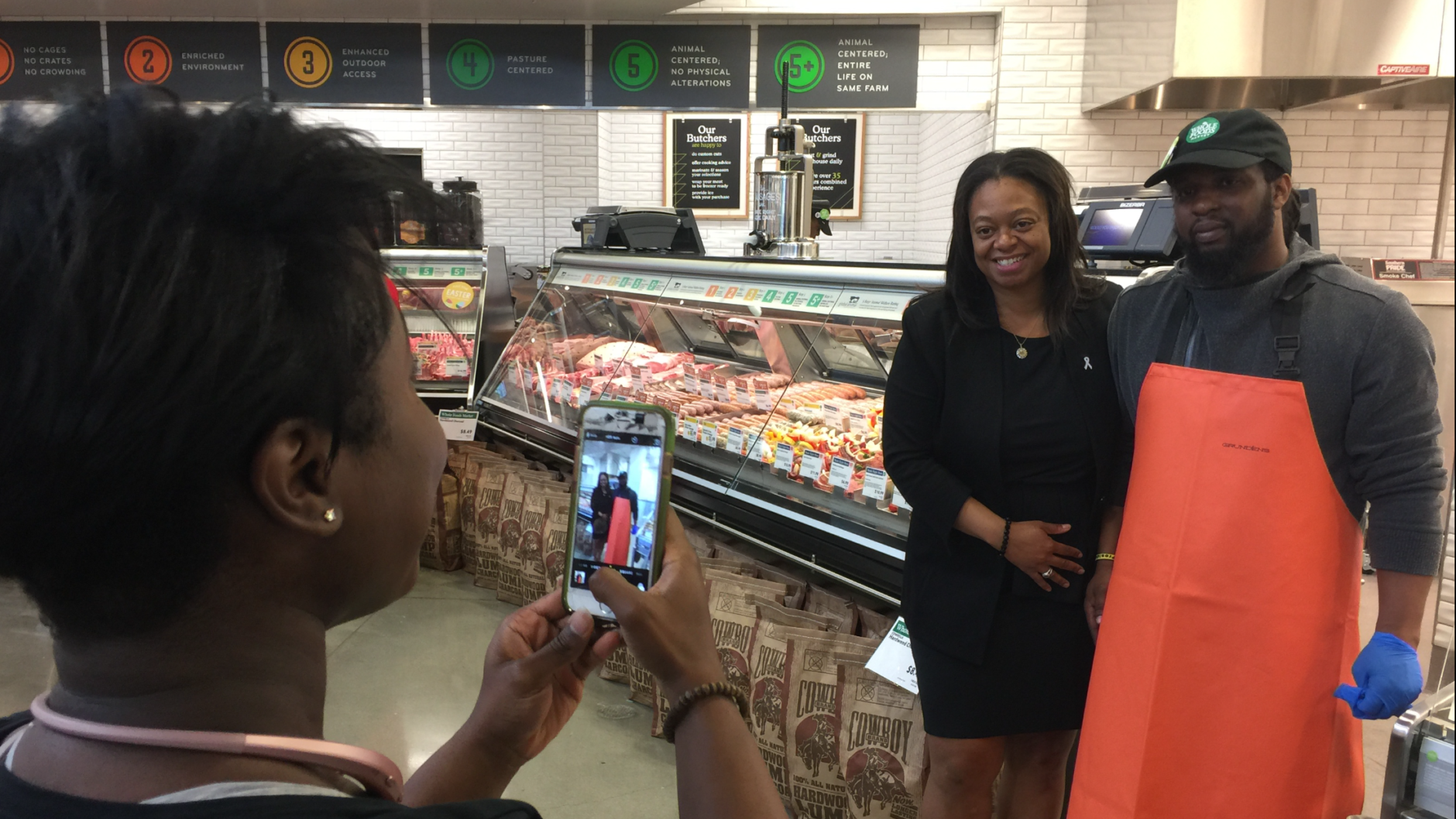 "I am so happy to see this come to fruition," said Prince George's County Councilwoman Karen R. Toles, shown getting her picture taken with Dennis Williams, of Capitol Heights. "This is the type of project and amenities we like to see in our beautiful Prince George's County." (WTOP/Kristi King)