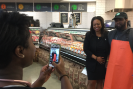 "I am so happy to see this come to fruition," said Prince George's County Councilwoman Karen R. Toles, shown getting her picture taken with Dennis Williams, of Capitol Heights. "This is the type of project and amenities we like to see in our beautiful Prince George's County." (WTOP/Kristi King)