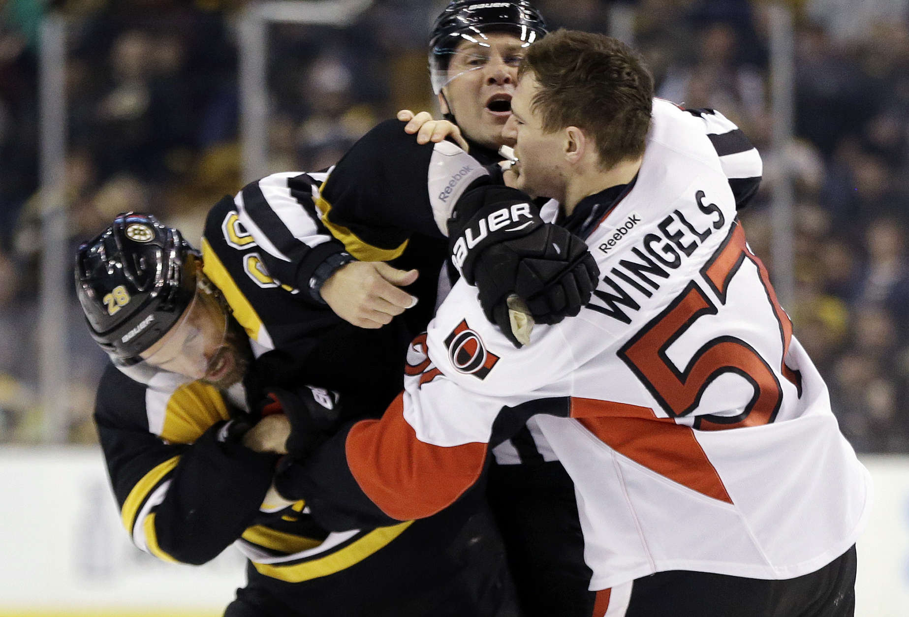 Boston Bruins center Dominic Moore (28) and Ottawa Senators center Tommy Wingels (57) fight during the second period of an NHL hockey game, Thursday, April 6, 2017, in Boston. (AP Photo/Elise Amendola)