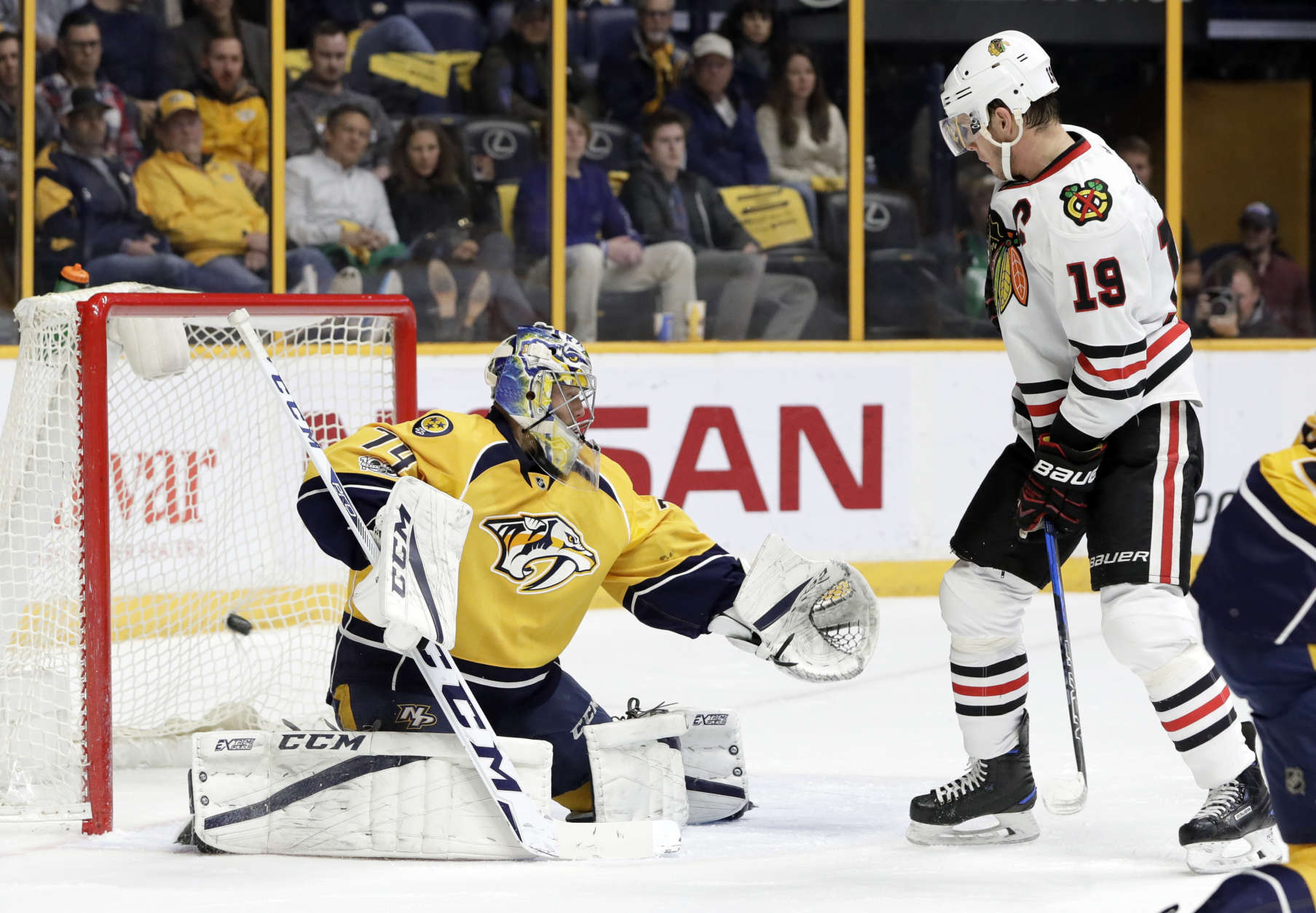 Chicago Blackhawks center Jonathan Toews (19) watches as a shot by teammate Patrick Kane gets past Nashville Predators goalie Juuse Saros (74), of Finland, for a goal during the first period of an NHL hockey game Saturday, March 4, 2017, in Nashville, Tenn. (AP Photo/Mark Humphrey)