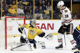 Chicago Blackhawks center Jonathan Toews (19) watches as a shot by teammate Patrick Kane gets past Nashville Predators goalie Juuse Saros (74), of Finland, for a goal during the first period of an NHL hockey game Saturday, March 4, 2017, in Nashville, Tenn. (AP Photo/Mark Humphrey)