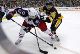 Pittsburgh Penguins' Conor Sheary (43) tries to check Columbus Blue Jackets' Kyle Quincey (26) off the puck during the second period of an NHL hockey game in Pittsburgh, Tuesday, April 4, 2017. (AP Photo/Gene J. Puskar)