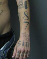 "187" and "Sin" are tattooed on Watson's arm. (Watson also has his name tattooed on his arm. (Courtesy Howard County Police Department))