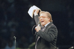 The Rev. Jimmy Swaggart gestures with the bible as spread the word of the Lord to the 14,000 faithful that packed the Los Angeles Sports Arena during his Los Angeles Crusade, Sunday, March 30, 1987. (AP Photo/Mark Avery)
