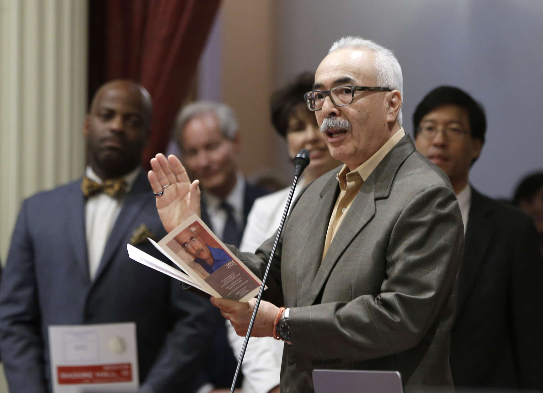 Juan Felipe Herrera, the newly appointed United States poet laureate, reads one of his poems before the California State Senate, Monday, July 6, 2015, in Sacramento,Calif. Herrera, 66, whose parents emigrated from Mexico, will be the nation's first Latino poet laureate since the position was created in 1936. (AP Photo/Rich Pedroncelli)