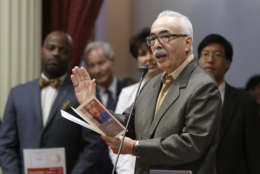 Juan Felipe Herrera, the newly appointed United States poet laureate, reads one of his poems before the California State Senate, Monday, July 6, 2015, in Sacramento,Calif. Herrera, 66, whose parents emigrated from Mexico, will be the nation's first Latino poet laureate since the position was created in 1936. (AP Photo/Rich Pedroncelli)